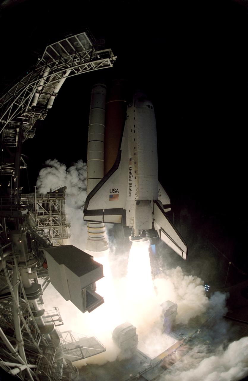 STS072-S-003 (11 Jan. 1996) --- A "fish-eye" lens was used to afford this unique view of the Space Shuttle Endeavour as it lifts off from Launch Pad 39B at the Kennedy Space Center (KSC).  Liftoff for STS-72 occurred at 4:41:00:072 a.m. (EST), January 11, 1996.  Onboard the spacecraft were astronauts Brian Duffy, commander; Brent W. Jett, pilot; along with Daniel T. Barry, Leroy Chiao, Winston E. Scott and Koichi Wakata, all mission specialists.  Wakata represents Japan's National Space Development Agency (NASDA).