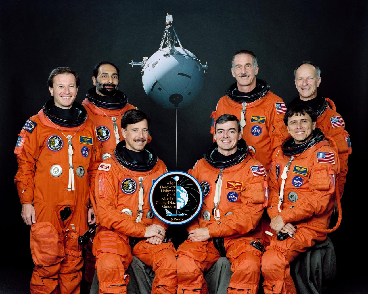 STS075-S-002 (December 1995) --- With their major payload as the backdrop, members of the crew pose for the traditional crew portrait.  The crew will deploy and work with the Tethered Satellite System (TSS-1R). Seated at center are astronauts Scott J. Horowitz (left), pilot; and Andrew M. Allen, commander. Astronaut Franklin R. Chang-Diaz (front right) is payload commander. In the rear are (left to right) European Space Agency (ESA) astronaut Maurizio Cheli, mission specialist; payload specialist Umberto Guidoni of the Italian Space Agency (ASI); Jeffrey A. Hoffman and ESA astronaut Claude Nicollier, mission specialists.