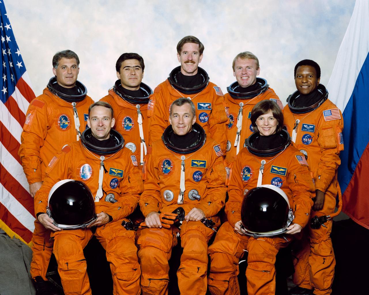 STS089-S-002 (Oct. 1997) --- These seven astronauts and one cosmonaut represent the flight crew for the STS-89 mission to Russia?s Mir Space Station. On the front row, from the left, are astronauts Joe F. Edwards, Jr., pilot; Terrence W. Wilcutt, commander; and Bonnie J. Dunbar, mission specialist. On the back row are David A. Wolf, currently onboard the Mir Space Station as a cosmonaut guest researcher; Salizan S. Sharipov, mission specialist representing the Russian Space Agency (RSA); James F. Reilly, mission specialist; Andrew S. W. Thomas, replacing Wolf aboard Mir as cosmonaut guest researcher; and Michael P. Anderson, mission specialist.