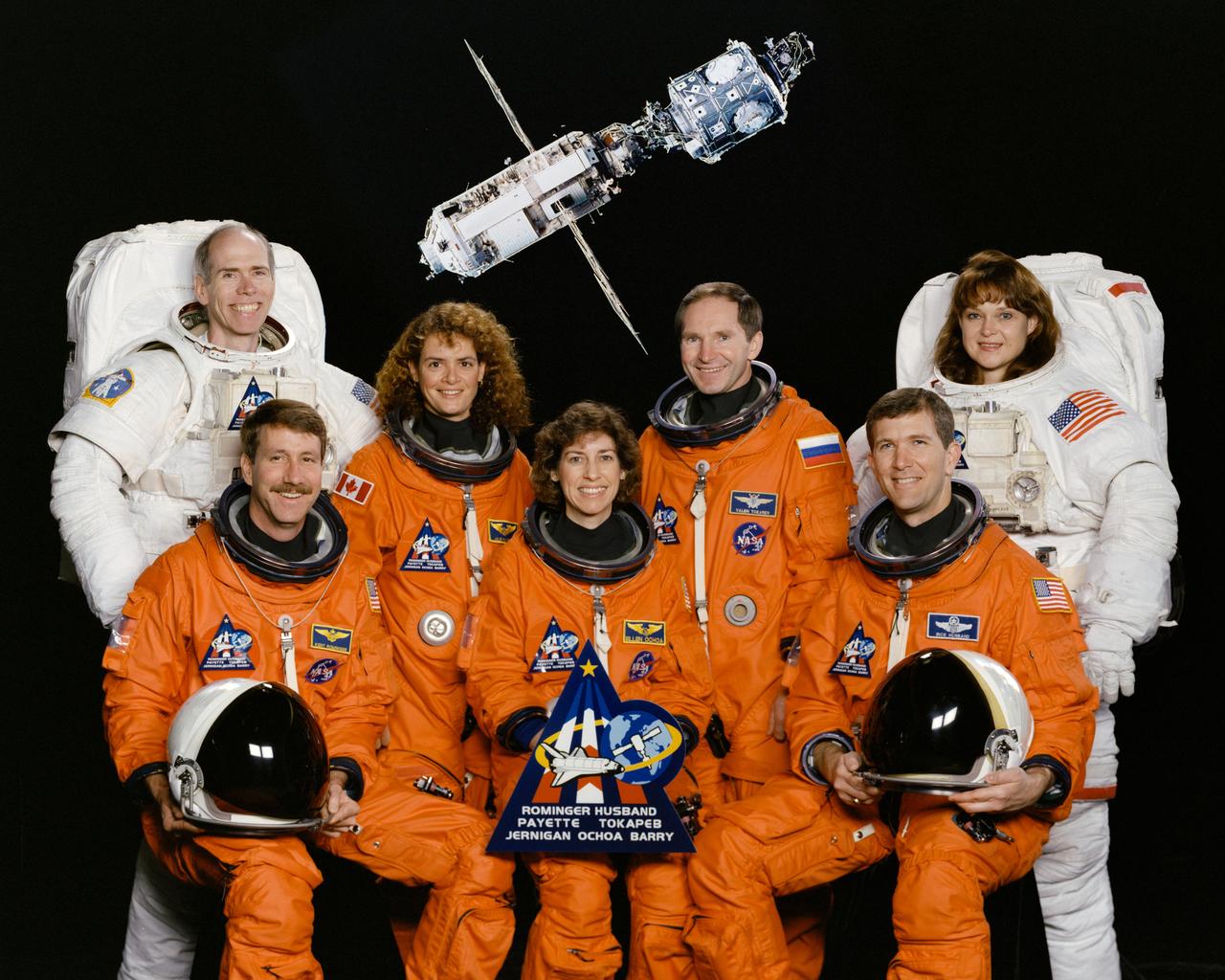 STS096-S-002 (April 1999) --- Six NASA astronauts and a Russian cosmonaut take a break from training to pose for the crew portrait.  Astronaut Kent V. Rominger, mission commander, is at left on the front row. Astronaut Rick D. Husband, pilot, is right. The remaining astronauts are Ellen Ochoa (front center) and, from the left on the back row, Daniel T. Barry, Julie Payette, Valeriy I. Tokarev, and Tamara Jernigan, all mission specialists. Payette represents the Canadian Space Agency (CSA) and Tokarev is with the Russian Space Agency (RSA). The crew will perform the first station docking and will become the first visitors to the new International Space Station (ISS) since its launch and start of orbital assembly last year. Space Shuttle Discovery's launch date is now scheduled for May 20.