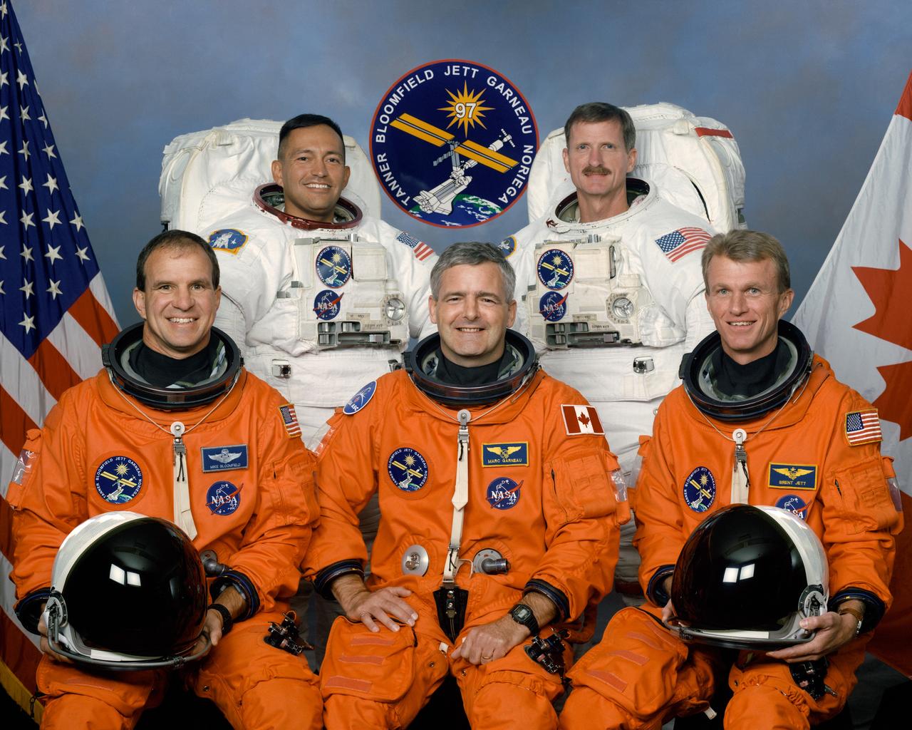 STS097-S-002 (November 1999) --- These five astronauts are in training for the STS-97 mission, scheduled to be launched next year aboard the Space Shuttle Endeavour for a working visit to the International Space Station (ISS). Astronauts Brent W. Jett (front right) and Michael J. Bloomfield (front left) are commander and pilot, respectively. Flanked by those two is astronaut Marc Garneau, mission specialist representing the Canadian Space Agency (CSA). In the rear are astronauts Carlos I. Noriega (left) and Joseph R. Tanner, both mission specialists. Noriega and Tanner are wearing training versions of the extravehicular mobility unit (EMU) spacesuits they'll be wearing for spacewalking chores during the flight.