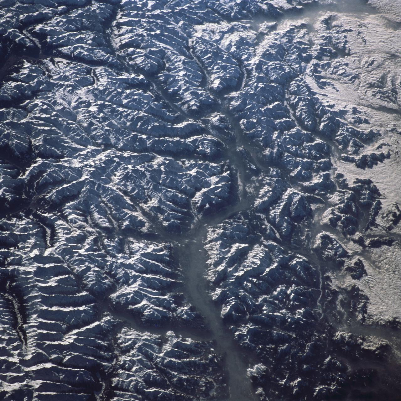 STS098-716-034 (18 February 2001) --- This east-to-west orbital view of the Inn River Valley of southern Austria was photographed by one the crew members of Atlantis during Space Shuttle Mission STS-98 on February 18, 2001, as the spacecraft orbited Earth at an altitude of 173 nautical miles (320 kilometers). Despite the heavy ground fog in the lower valleys, this 70mm handheld camera's photo provides a strikingly detailed view of the Italian, Swiss and Austrian Alps of central Europe. For example, the famous Brenner Pass, an historic gateway connecting Italy to the rest of Europe, can be seen in the left central foreground. The Austrian city of Innsbruck on the Inn River, scene of the 1964 and 1976 Winter Olympics, and normally visible in great detail, is completely masked by heavy ground fog. Center coordinates of the pictured area are located at 47.5 degrees north latitude and 12.5 degrees east longitude.