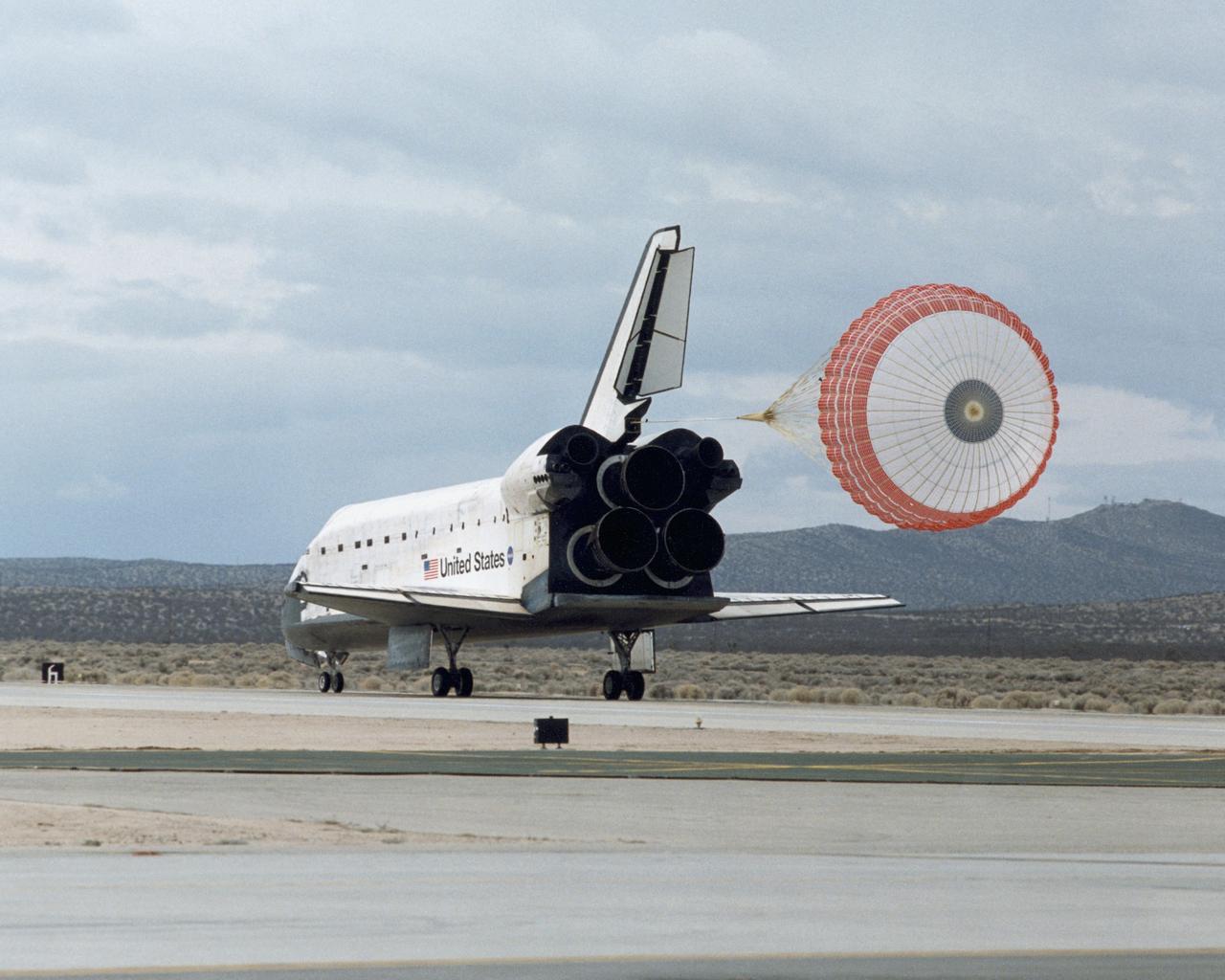 STS098-S-017 (20 Feb. 2001) --- A drag chute slows down the space shuttle Atlantis following its touchdown to mark mission completion at Edwards Air Force Base in the Mojave Desert of California. Onboard were astronauts Kenneth Cockrell, Mark Polansky, Robert Curbeam, Thomas Jones and Marsha Ivins. Atlantis touched down on Edward?s concrete runway at 2:33 p.m. (CST), Feb. 20, for a mission elapsed time of 12 days, 21 hours and 20 minutes. Photo credit: NASA