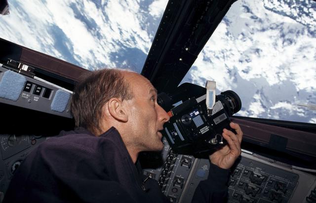 NASA image: STS-99 MS Thiele aims a camera out of a window on OV-105's flight deck