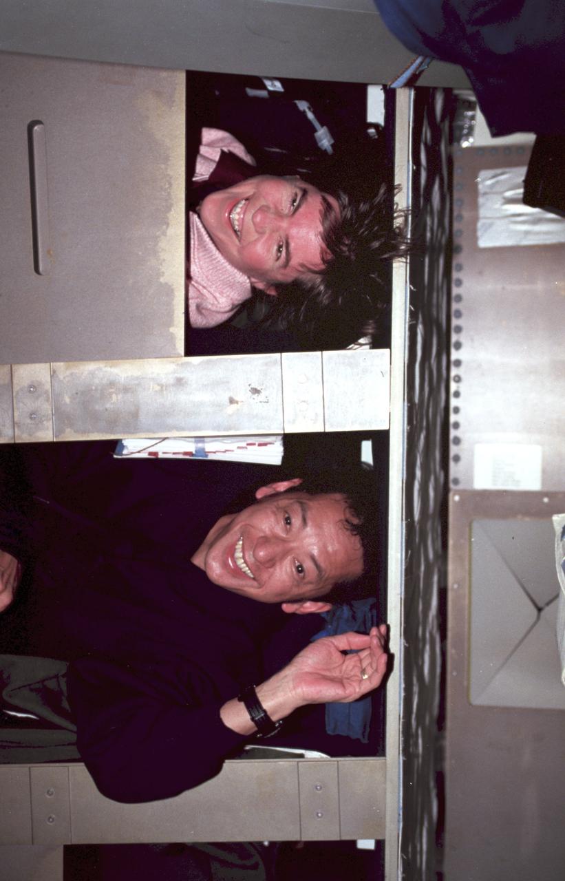 STS099-308-019 (11-22 February 2000) ---Astronauts Janice E. Voss and Mamoru Mohri, both members of the Blue Team portion of 24-hour SRTM support, prepare for their sleep shift on the middeck of the Earth-orbiting Space Shuttle Endeavour. Mohri represents Japan?s National Space Development Agency (NASDA).