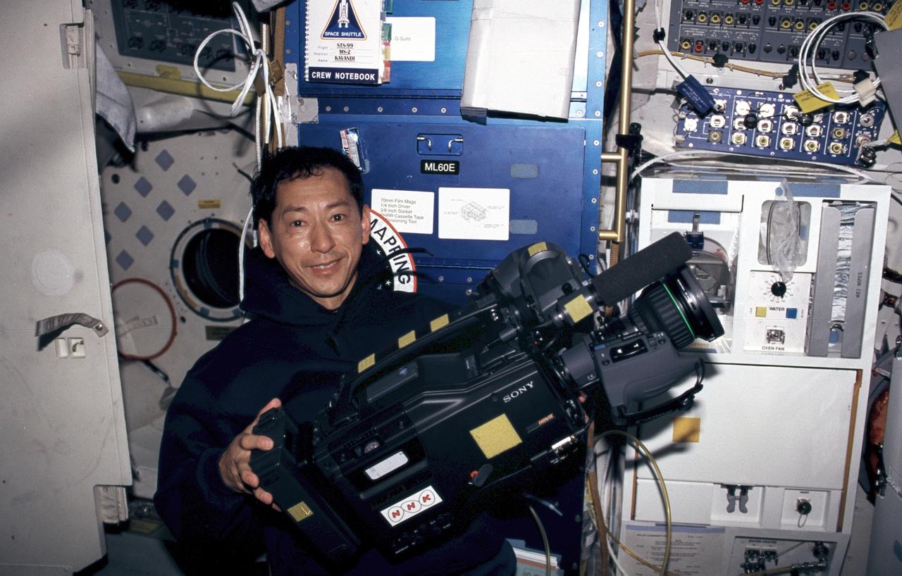 STS099-308-034 (11-22 February 2000) ---  Astronaut Mamoru Mohri, mission specialist, is about to use the High Definition Television (HDTV) camera on Endeavour's middeck. The National Space Development Agency's (NASDA) astronaut supported the Blue Team during the SRTM flight.  Endeavour's galley can be seen in the background.