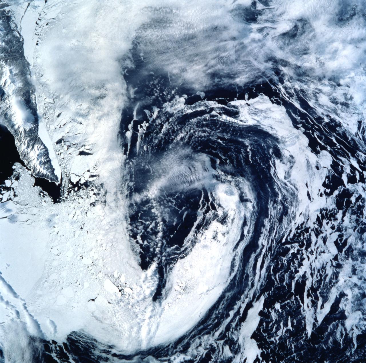 STS099-722-077 (11-22 February 2000) ---Both topography and bathymetry combine with wind and sea currents to produce a pattern of sea ice in the extreme southern Sea of Okhotsk, in this scene photographed by one of the STS-99 crew members aboard the Space Shuttle Endeavour.  The rugged shoreline of north Hokkaido and the Kurile Archipelago have channeled northerly winds and surface waters into a gyre here, clearly depicted in the pattern of sea ice.