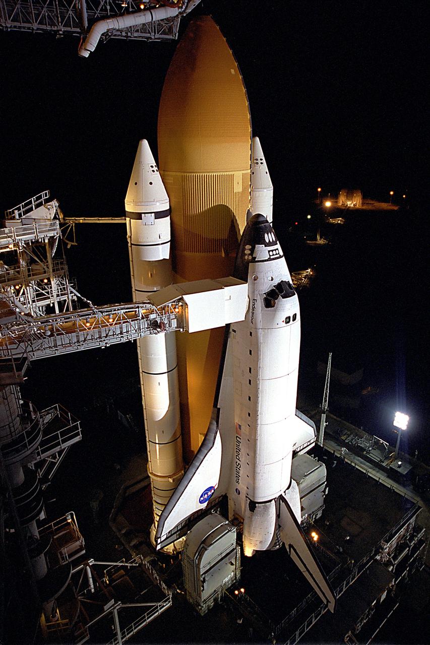 STS099-S-020 (10 February 2000) --- The Space Shuttle Endeavour awaits liftoff only hours away on Launch Pad 39A at the Kennedy Space Center (KSC).  The point of view is from the Rotating Service Structure more than 225 feet above the ground.  Abutting the side of Endeavour is the orbiter access arm with the environmental chamber known as the White Room at the end.  The White Room provides access to the crew compartment. This flight represents the 97th in the Space Transportation System (STS) program and marks the 14th mission for the Space Shuttle Endeavour.