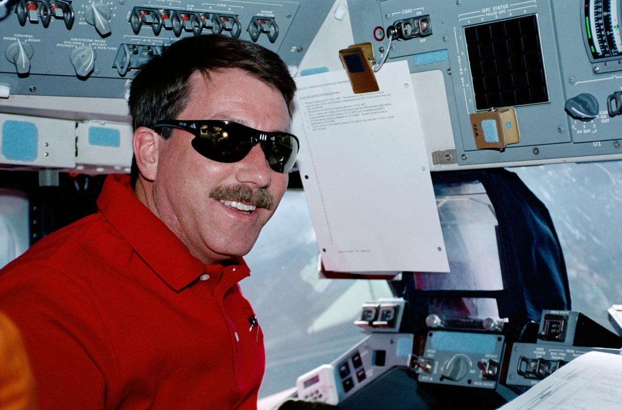 STS100-303-004 (19 April-1 May 2001) --- Astronaut Kent V. Rominger, STS-100 commander, looks over a procedures checklist at the commander's station on the forward flight deck of the Earth-orbiting Space Shuttle Endeavour.