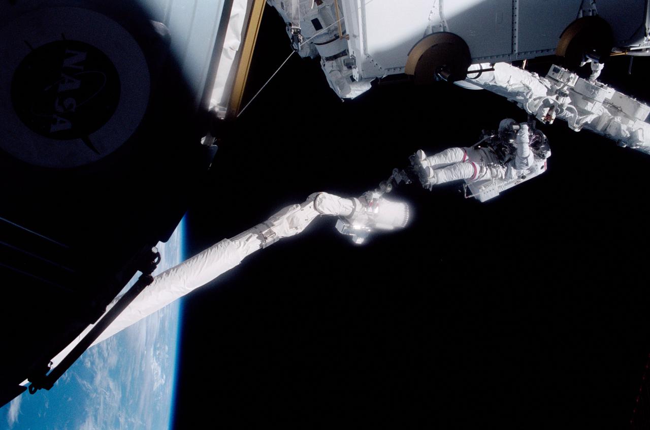 STS100-333-028 (19 April-1 May 2001) --- Astronaut Chris A. Hadfield, STS-100 mission specialist representing the Canadian Space Agency (CSA), stands on the portable foot restraint (PFR) connected to the Endeavour's remote manipulator system (RMS) robotic arm, using an International Space Station (ISS) pistol grip tool during one of two days of extravehicular activity (EVA).