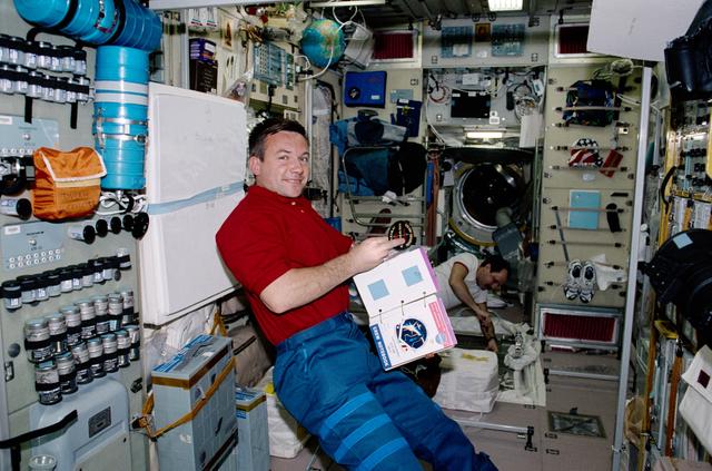 NASA image: Lonchakov and Usachev work on TVIS in Zvezda during STS-100's visit