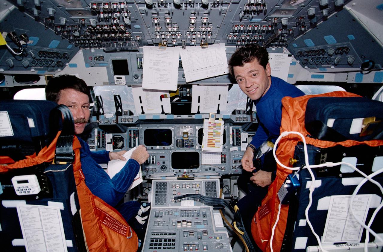STS100-363-034 (19 April-1 May 2001) --- Astronauts Kent V. Rominger (left) and Jeffrey S. Ashby, STS-100 commander and pilot, respectively, are photographed on the flight deck of the Space Shuttle Endeavour during de-orbit preparations.