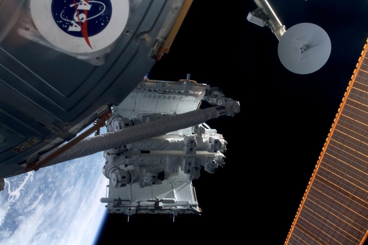STS100-388-010 (19 April-1 May 2001) --- In the grasp of the shuttle's remote manipulator system (RMS) robot arm, the Spacelab pallet is installed on the Lab Cradle Assembly (LCA) on the International Space Station (ISS).