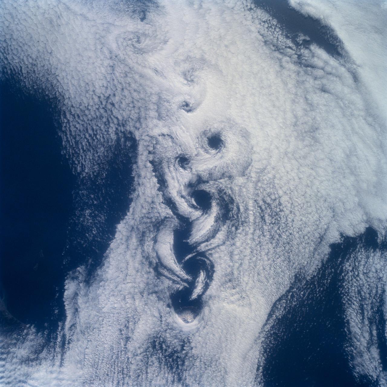 STS100-710-182 (19 April-1 May 2001) --- Easily recognizable in this STS-100 70mm frame are phenomena known as the von Karman vortices, which were forming in the stratocumulus field downwind from the volcanic island of Rishiri-to in the northern Sea of Japan off the northwest coast of Hokkaido, Japan. According to NASA scientists studying the STS-100 photo collection, these features form when a stable atmosphere with low clouds flows past a relatively small obstacle with a height greater than the depth of the cloud layer.  Because the atmosphere is stable, a series of eddies form in the moving cloud field.