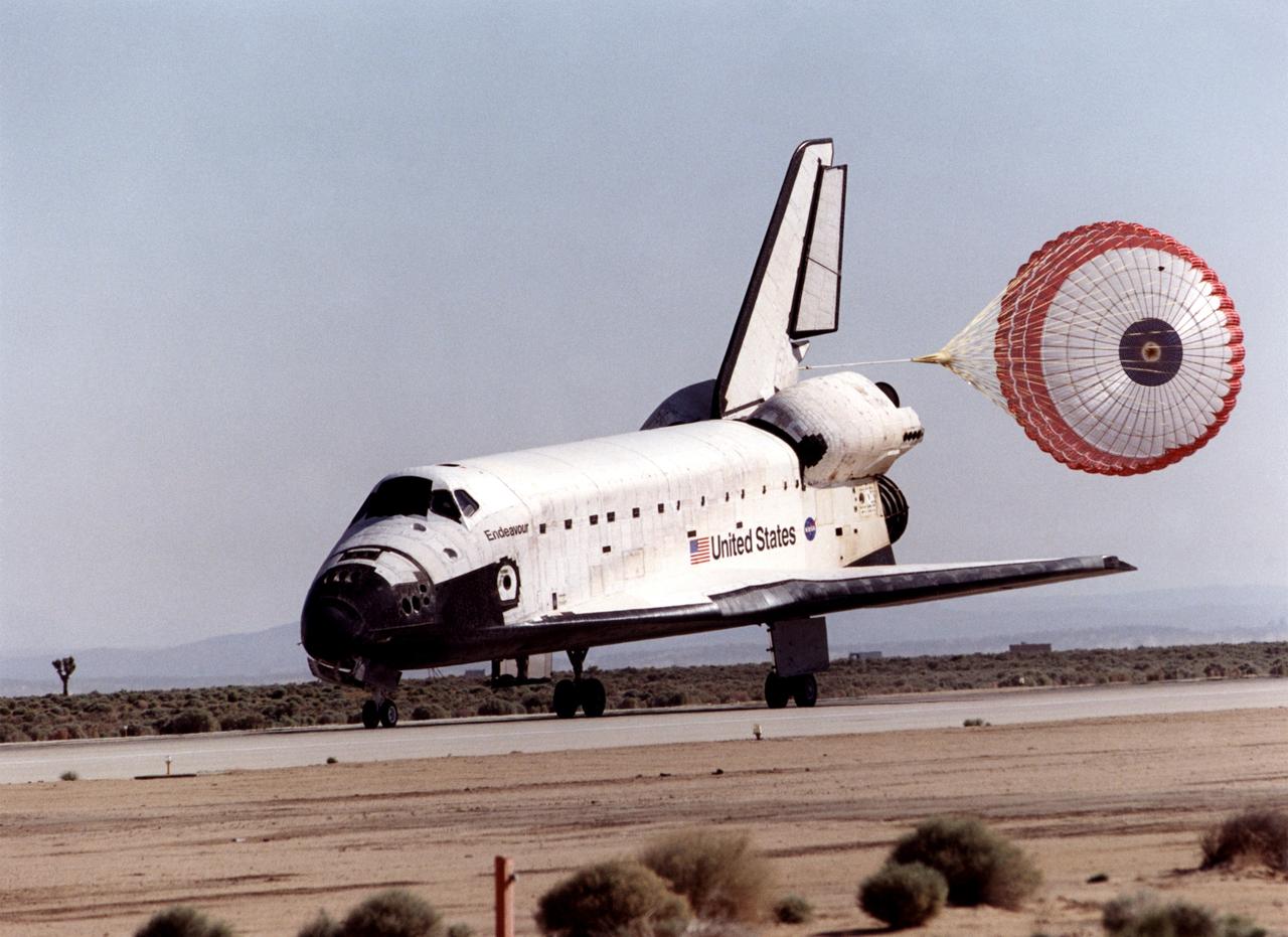 STS100-S-020 (1 May 2001) --- The drag chute on the space shuttle Endeavour helps to slow the vehicle down as it eases to the completion of the STS-100 mission on a desert runway at Edwards Air Force Base in California. Touchdown occurred at 9:11 a.m. (PDT), May 1, 2001. Onboard the shuttle were six NASA astronauts and a cosmonaut representing Rosaviakosmos. Photo credit: NASA