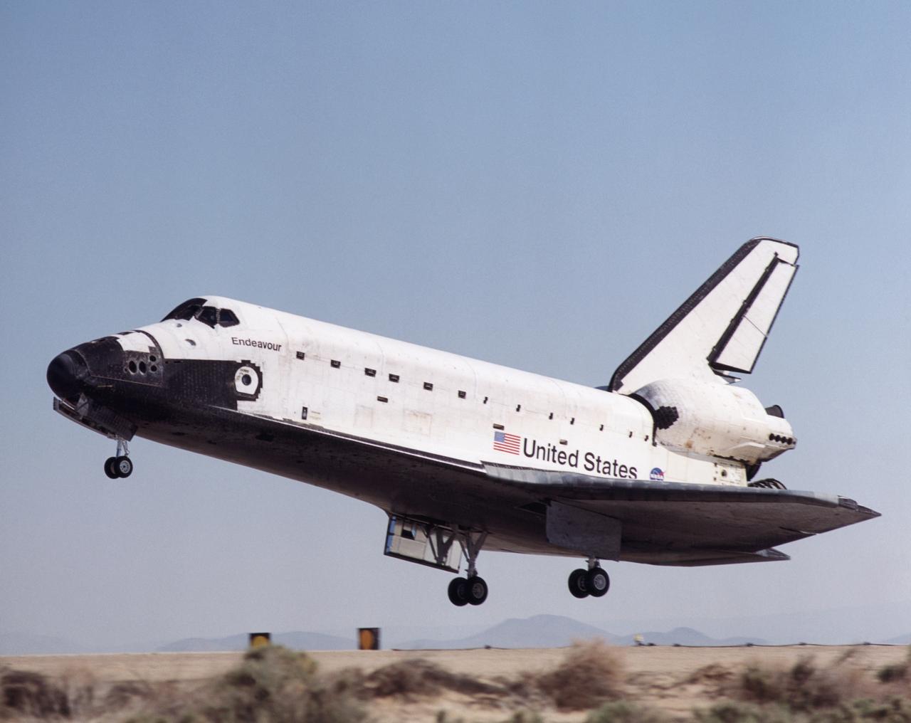 STS100-S-023 (1 May 2001) --- The space shuttle Endeavour is only seconds away from main gear touchdown on a desert runway at Edwards Air Force Base in California to complete the STS-100 mission. Touchdown occurred at 9:11 a.m. (PDT), May 1, 2001. Onboard the shuttle were six NASA astronauts and a cosmonaut representing Rosaviakosmos. Photo credit: NASA