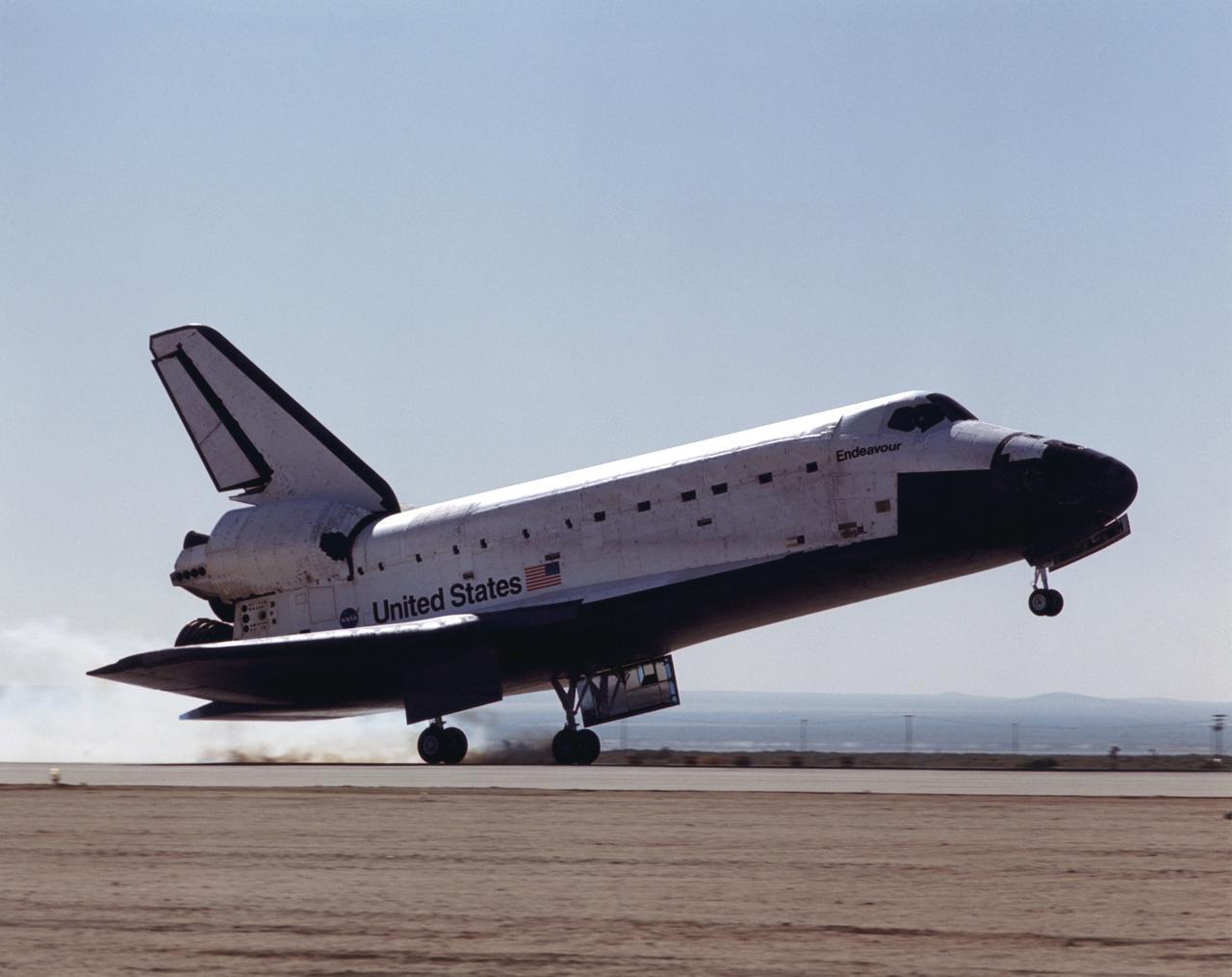 STS100-S-024 (1 May 2001) --- The main landing gear on the space shuttle Endeavour touches down on a desert runway at Edwards Air Force Base in California to complete the STS-100 mission. Touchdown occurred at 9:11 a.m. (PDT), May 1, 2001. Onboard the shuttle were six NASA astronauts and a cosmonaut representing Rosaviakosmos. Photo credit: NASA