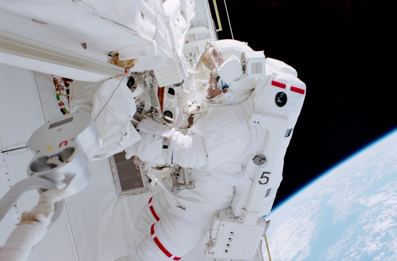 STS102-315-025 (8-21 March 2001)--- Astronaut Andrew S. W. Thomas, mission specialist, was captured on film by astronaut Paul W. Richards, mission specialist, while in the cargo bay of the Earth-orbiting Space Shuttle Discovery during the second space walk of the STS-102 mission.