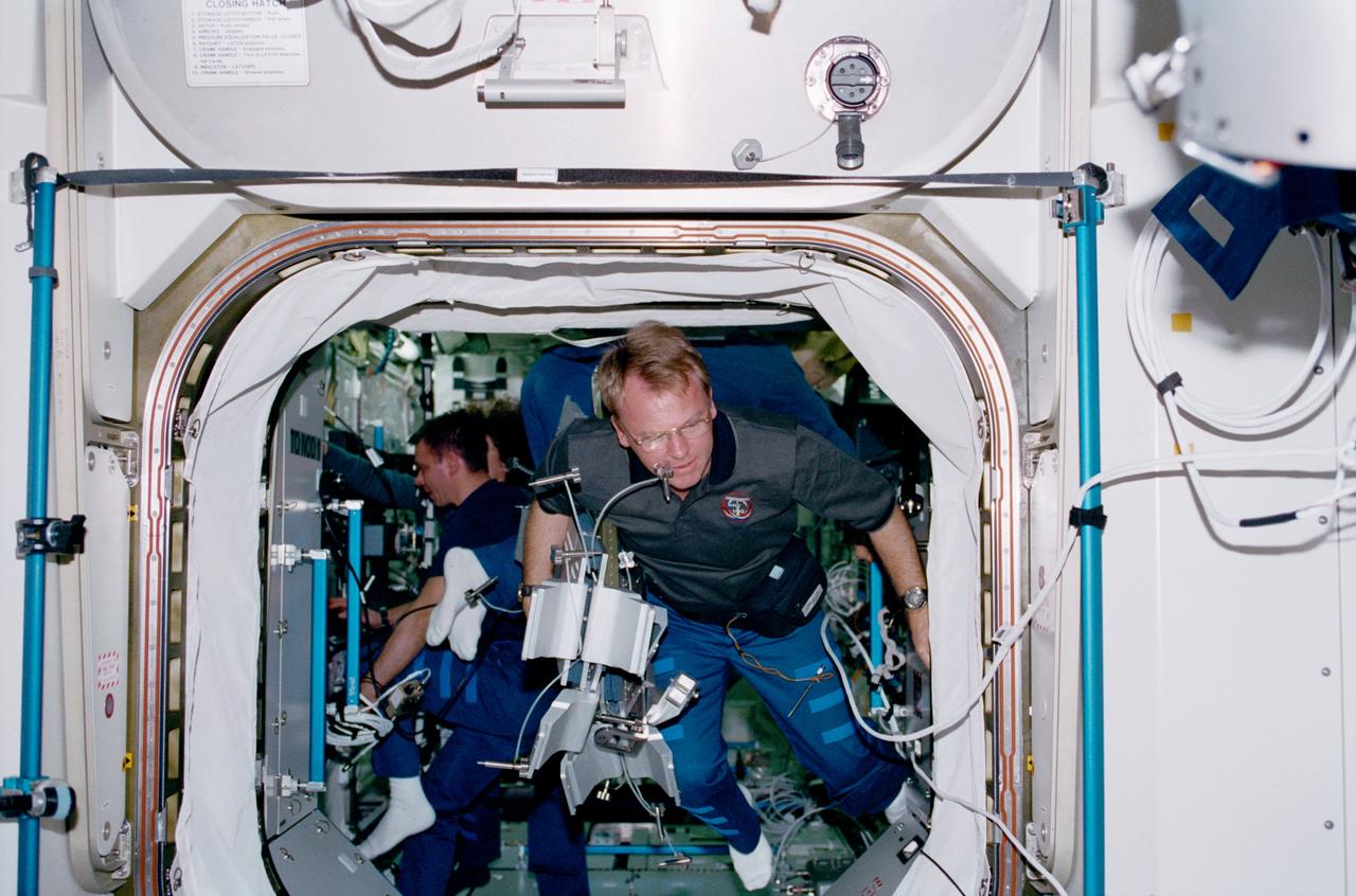STS102-319-010 (8 - 21  March 2001) --- Astronaut Andrew S.W. Thomas, STS-102 mission specialist, floats near the hatchway for the Destiny laboratory.  Cosmonaut Yuri P. Gidzenko, a member of the Expedition One crew, can be seen in the background.