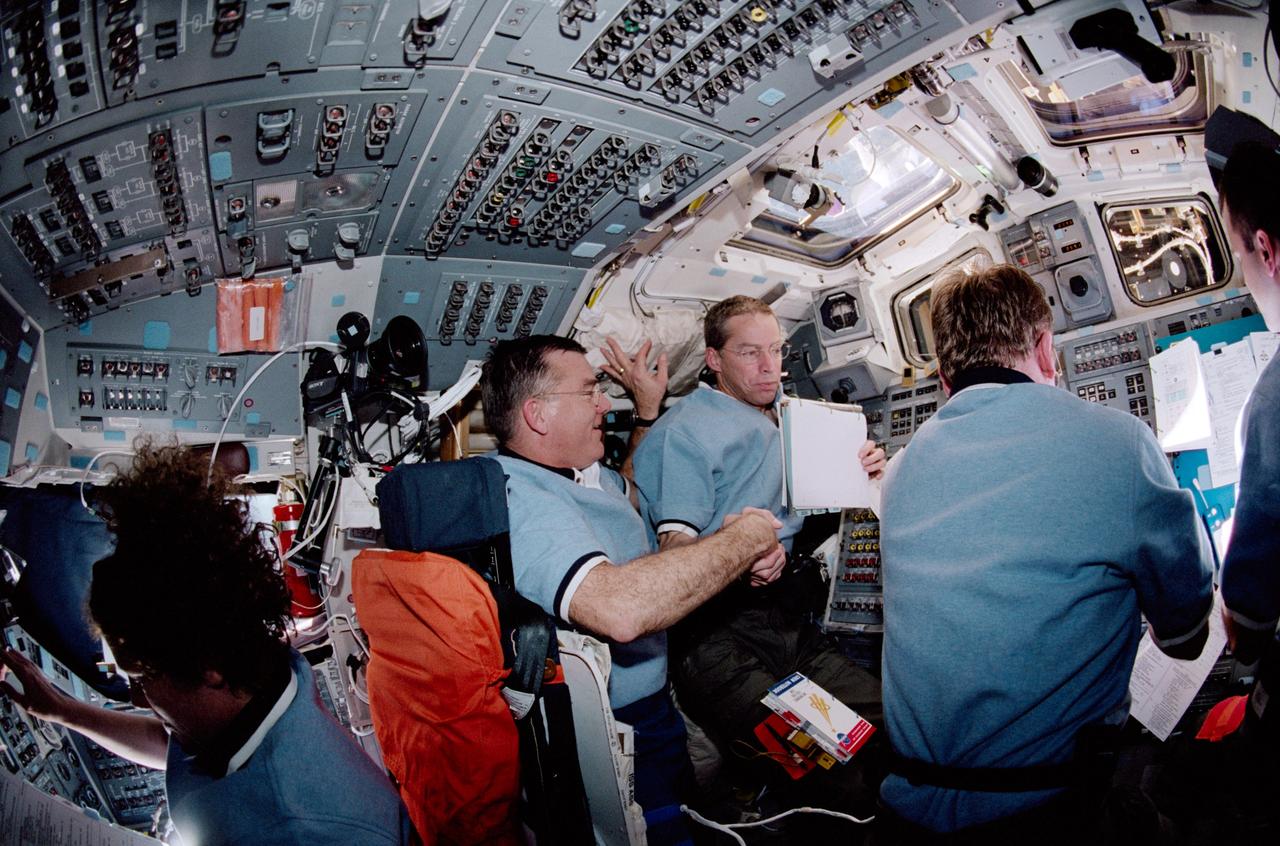 STS102-323-003 (10 March 2001) --- The STS-102 crew members are pictured on the   aft flight deck of the Space Shuttle Discovery during docking operations with the International Space Station (ISS).  From the left are astronauts James S. Voss, James D. Wetherbee and Andrew S.W.  Thomas.