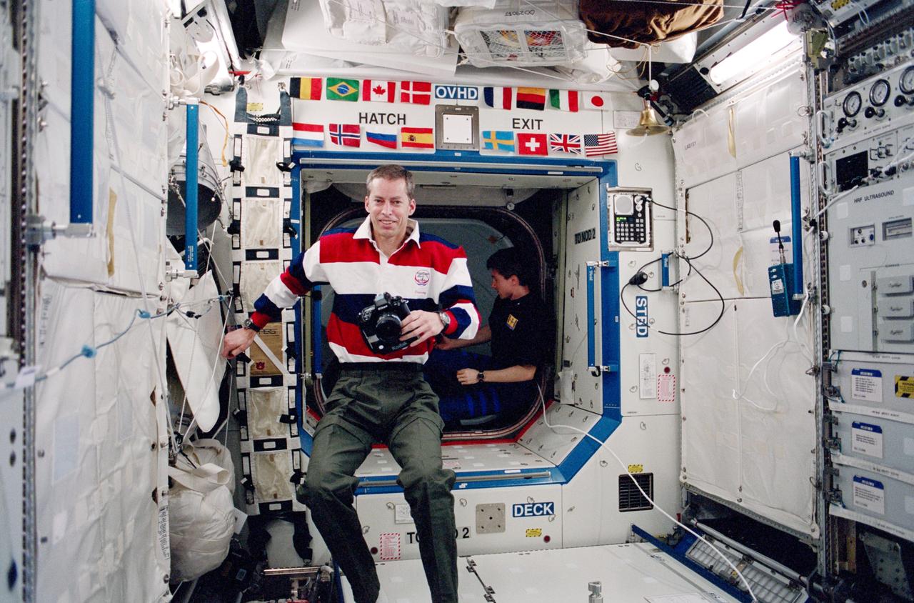 STS102-324-019 (8-21 March 2001) --- Astronaut James D. Wetherbee, STS-102 commander, is photographed while onboard the Destiny laboratory on the International Space Station (ISS). Cosmonaut Sergei K. Krikalev, Expedition One flight engineer representing Rosaviakosmos, is visible in the background.