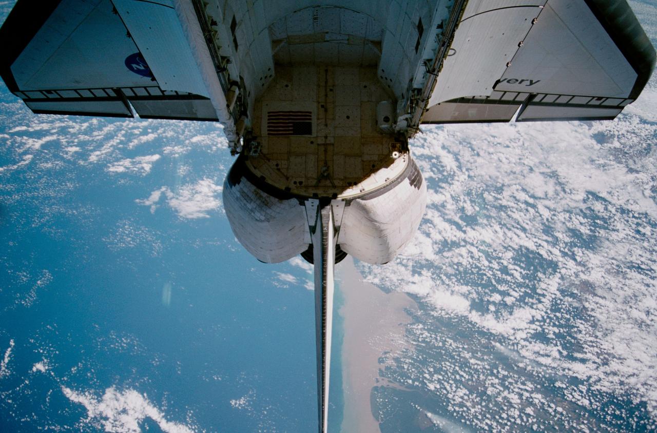 STS102-328-028 (13 March 2001) --- The  Space Shuttle Discovery's payload bay  and vertical stabilizer are backdropped over Southeast Asia in this 35mm scene.