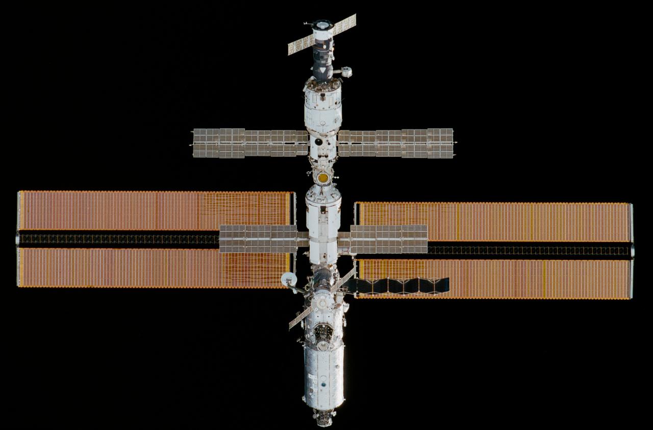 STS102-329-037 (8-21 March 2001)--- Backdropped against the blackness of space, the International Space Station (ISS) was photographed with a 35mm camera by one of the astronauts onboard the Discovery following separation of the station and the shuttle.