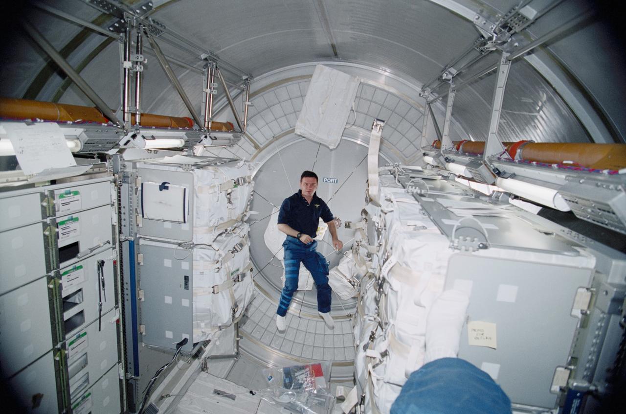 STS102-343-008 (8 - 21 March 2001) ---  Cosmonaut Yuri P. Gidzenko is dwarfed by transient hardware aboard Leonardo, the Italian Space Agency-built Multipurpose Logistics Module (MPLM). Gidzenko has been aboard the International Space Station (ISS) since early November of 2000, but he will be returning to Earth with the STS-102 astronauts and the MPLM  in a few days.