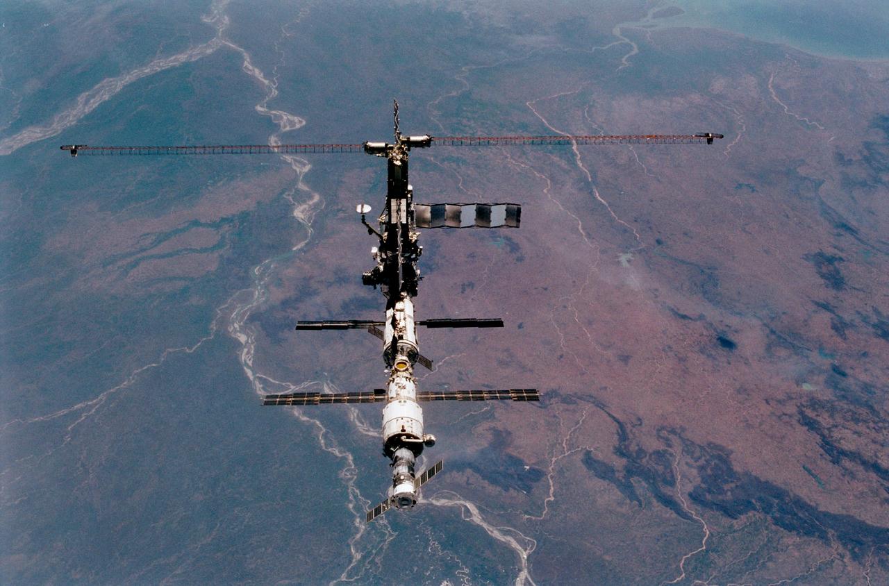 STS102-357-031 (18 March 2001)---The International Space Station (ISS) is backdropped over the Ganges River in India in this post-separation fly-around  35mm frame photographed from the Space Shuttle Discovery.