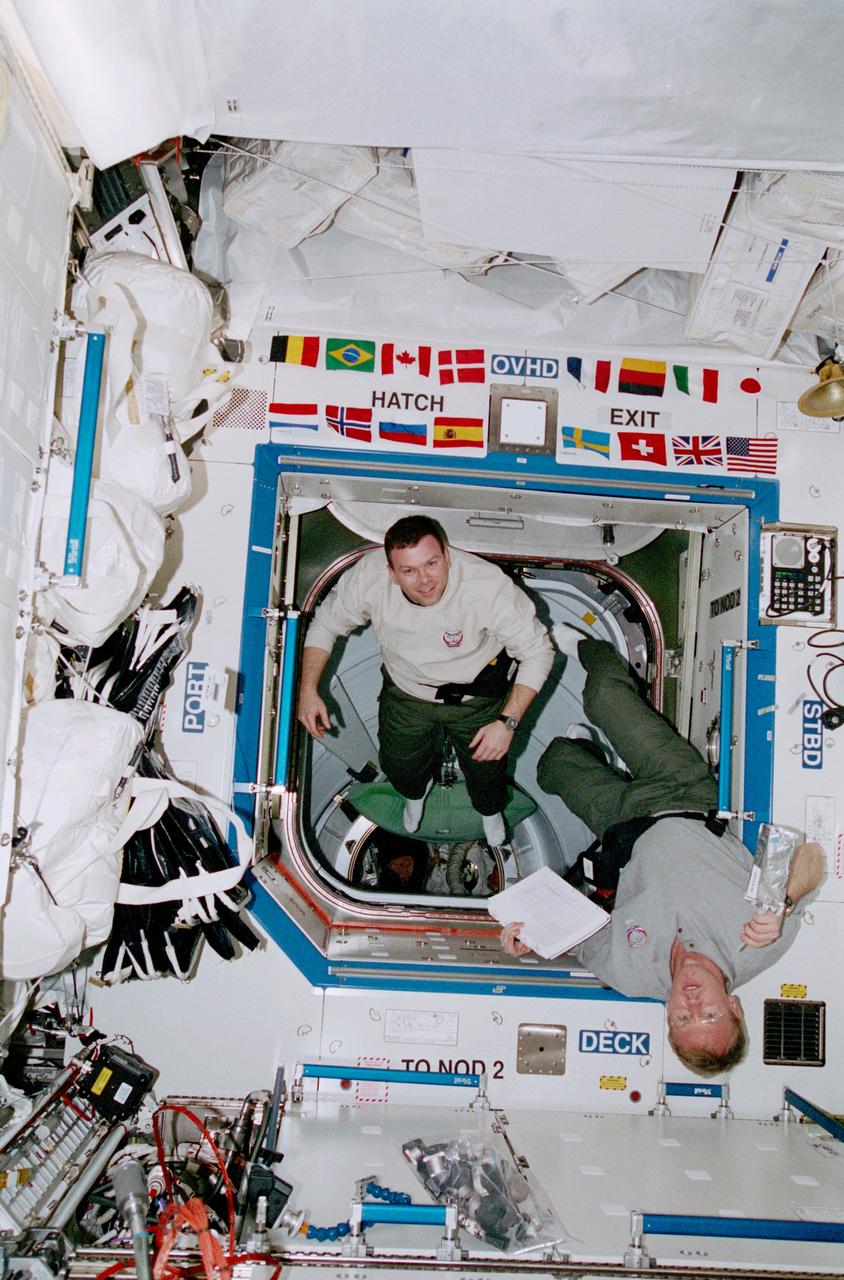 STS102-368-030 (8-21 March 2001) --- Astronauts Andrew S. W. Thomas (holding a beverage), STS-102 mission specialist and James M. Kelly, STS-102 pilot, are photographed while onboard the Destiny laboratory on the International Space Station (ISS).
