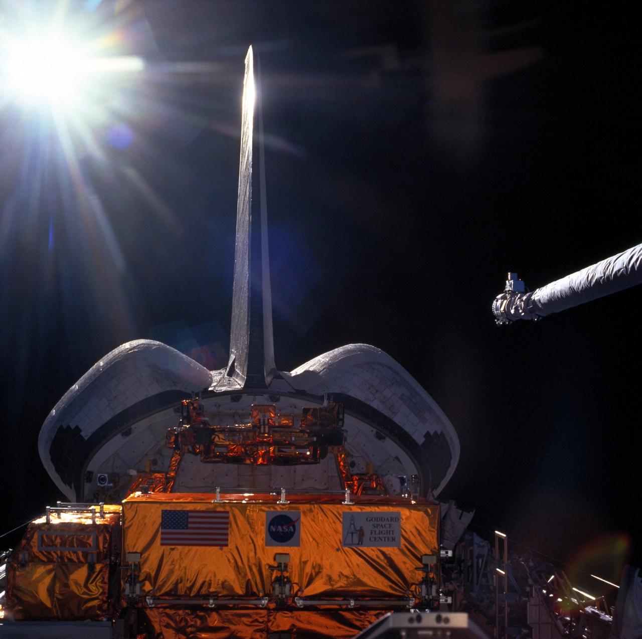 STS103-707-010 (19-27 December 1999) ---  The end effector of the Remote Manipulator System (RMS, right center) on the Space Shuttle Discovery awaits the arrival of the approaching Hubble Space Telescope (HST, out of frame) prior to telescope capture.