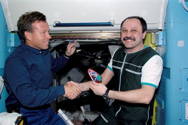 NASA image: Expedition Two CDR Usachev and STS-104 CDR Lindsey in Quest airlock hatch