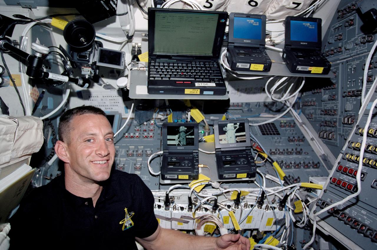 STS104-326-005 (12-24 July 2001) ---  Astronaut Charles O. Hobaugh, STS-104 pilot, prepares to do some work at the  recently-fashioned computer network  station on the flight deck of the Space Shuttle Atlantis.