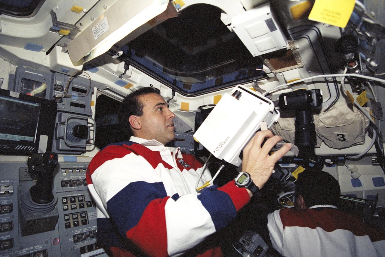 STS106-320-014 (10 September 2000) ---  Astronaut Richard A. Mastracchio, mission specialist, uses a handheld laser device on the aft flight deck of the  Space Shuttle Atlantis to track the range of the International Space Station during rendezvous operations.