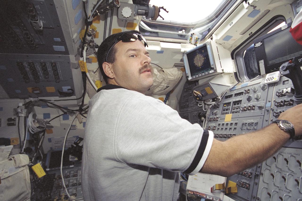 STS106-320-018 (17 September 2000) --- Astronaut Scott D. Altman, STS-106 pilot, controls the intricate maneuvers of the shuttle during undocking procedures with the International Space Station (ISS) from the aft flight deck of the Space Shuttle Atlantis.