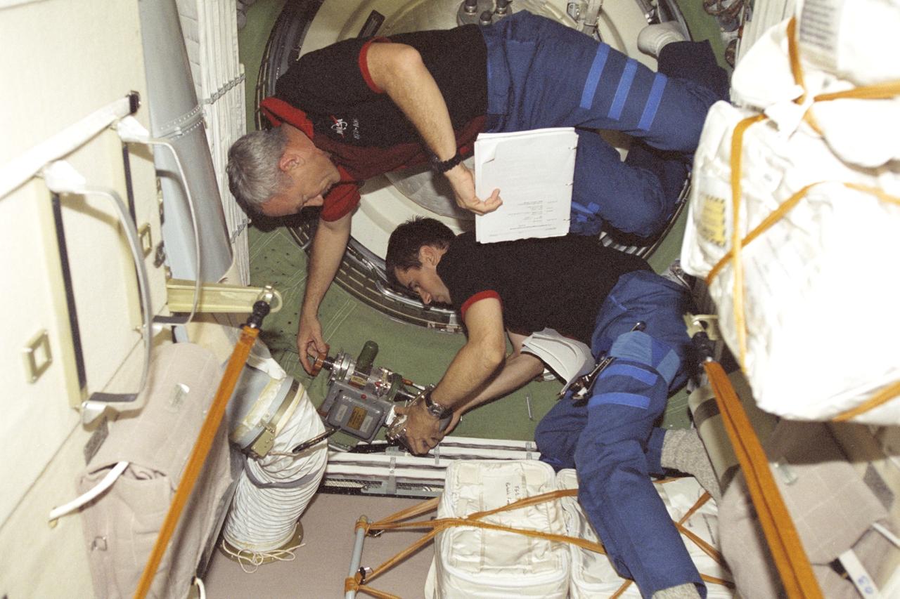 STS106-322-026 (17 September 2000) --- Astronaut Terrence W. Wilcutt (right), STS-106 mission commander, and cosmonaut Yuri I. Malenchenko, mission specialist, in the functional cargo block (FGB) or Zarya on the International Space Station (ISS), work on preparations for undocking between the Space Shuttle Atlantis and the station. Separation took place on September 17, 2000 at 10:46 p.m. (CDT). Malenchenko represents Rosaviakosmos.