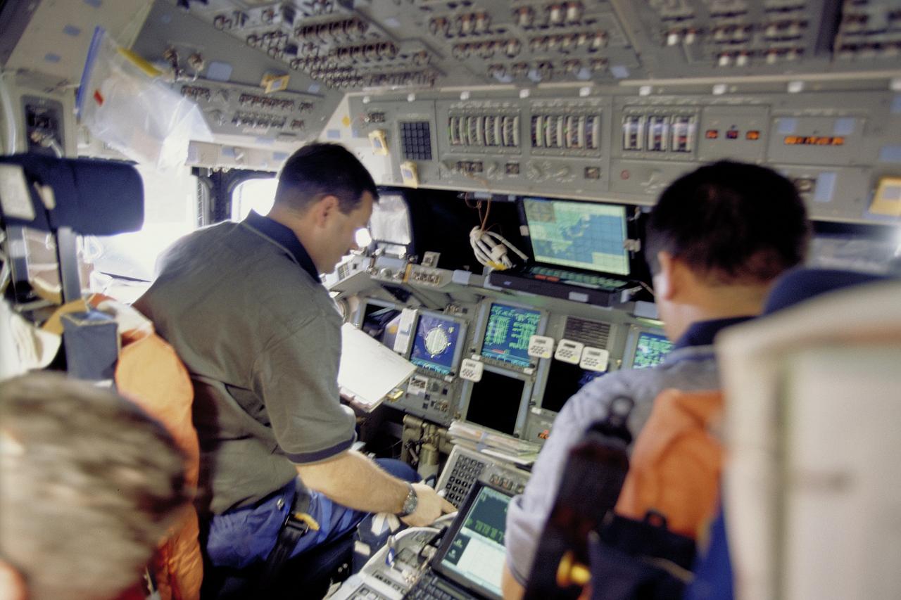 STS106-335-022 (8-20 September 2000) --- Astronauts Scott D. Altman (left), STS-106 pilot, occupies the commander’s station in the forward flight deck of the Space Shuttle Atlantis during rendezvous procedures for docking with the International Space Station (ISS). Astronaut Edward T. Lu, mission specialist, can be seen in the pilot’s station.
