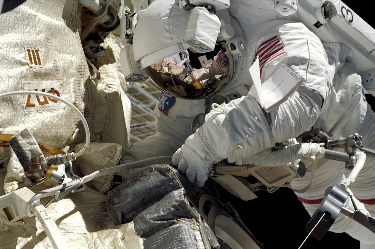 S106-349-012 (11 September 2000) --- Astronaut Edward T. Lu, mission specialist, was captured on film   by his spacewalking colleague, cosmonaut Yuri I. Malenchenko, during the 6-hour-plus  space walk the two performed on the exterior of the International Space Station (ISS).  Malenchenko was one of two mission specialists on the 12-day flight who represented the Russian Aviation and Space Agency.