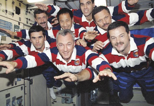 STS-106 crewmembers in Superman pose for a group photograph on Zvezda
