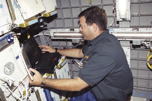 NASA image: Pilot Altman works with the SOAR laptop computer in SpaceHab during STS-106