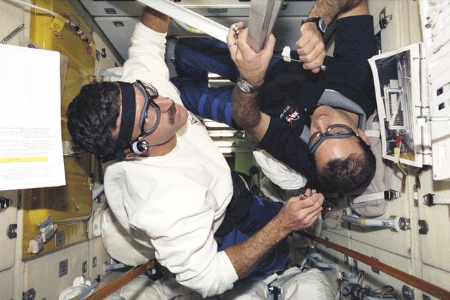 NASA image: Burbank and Mastracchio work on the TORU container in Zarya during STS-106