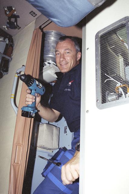 NASA image: Commander Wilcutt removes restraining bolts in Zvezda during STS-106