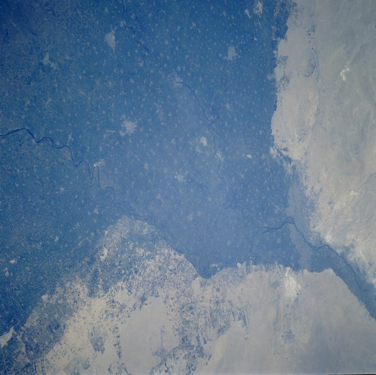 STS106-701-025 (8-20 September 2000) --- One of the STS-106 crew members on board the Space Shuttle Atlantis used a handheld 70mm camera to photograph this image of Cairo, Egypt, the largest city in Africa. Its population is nearly 16 million, a figure which translates to approximately 130,000 people per square mile. Metropolitan Cairo shows as a gray area in the green of the Nile River valley at the apex of the Delta. The shadows of the three major pyramids at Giza on the Western edge of the city are visible. They are right below the bright new road construction. This side of the metropolitan area is experiencing rapid growth. According to geologists who have been studying shuttle-to-Earth imagery for many years, this photograph documents some of the many changes in land use in the Western Desert.