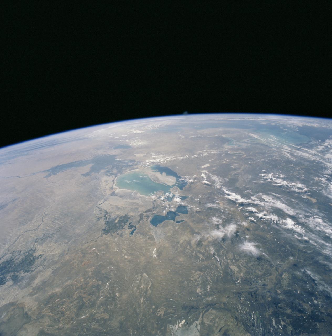STS106-704-092 (8-20 September 2000) --- One of the STS-106 crew members on board the Space Shuttle Atlantis used a handheld 70mm camera to photograph this image of the Aral Sea in Kazakhstan and Uzbekistan. According to geologists that have been studying aerial and space-to-Earth photos, the Aral Sea has diminished dramatically since the 1950's. By 1990, the surface area of the Aral had decreased by more than 50 percent, and the salinity had tripled since 1960, when the sea covered about 68,000 square kilometers. The most noticeable changes observed from orbit between January, 1998 and September, 2000 have been the expansion of the large north-trending island, the decrease in total water area, and the isolation of the smaller northern water body.