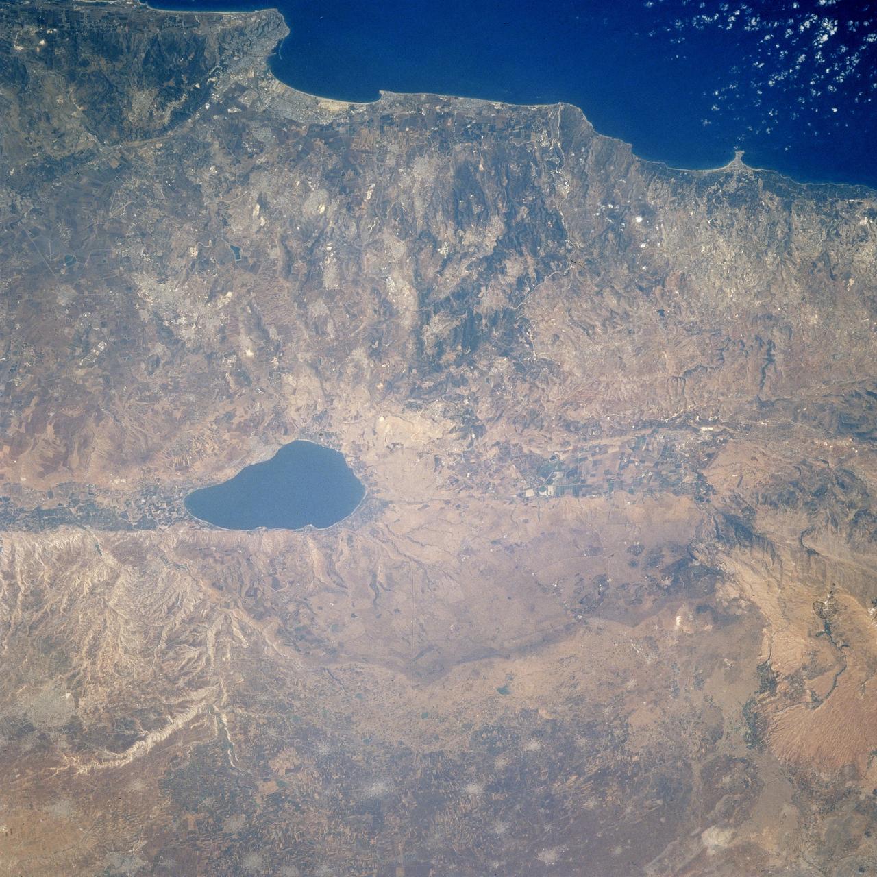 STS106-713-002 (19 September 2000)  --- One of the STS-106 crew members on board the Space Shuttle Atlantis, 204 nautical miles above Earth, used a handheld 70mm camera to photograph this image featuring the Sea of Galilee and part of the Mediterranean coast. Also known as Lake Tiberius and other names, the body of water is the only natural fresh-water lake in Israel. It borders on the Golan Heights on its east side. The port of Haifa is visible on the  Mediterranean coast. The large agriculture projects on the Israeli side of Galilee are irrigated by the lake and the Jordan River.
