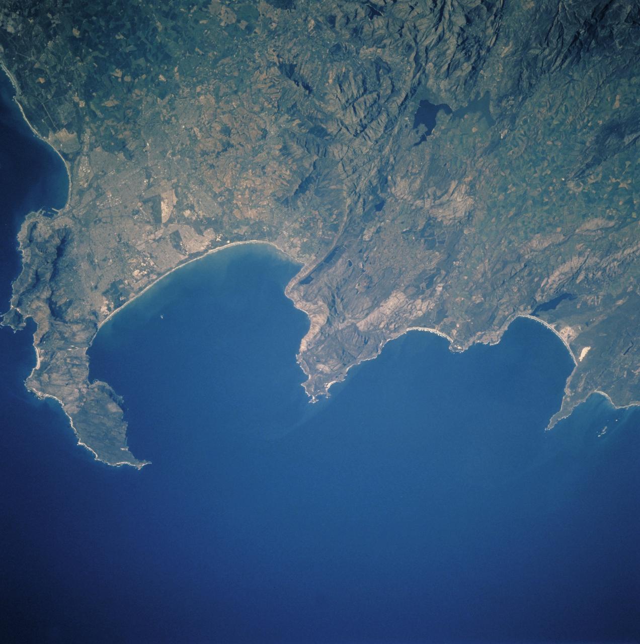 STS106-713-057 (19 September 2000)  --- One of the STS-106 crew members on board the Space Shuttle Atlantis used a handheld 70mm camera to photograph this image of Cape Town and the Karroo Ranges in South Africa. Cape Town occupies the north end of the Cape of Good Hope peninsula and extends to the shore of False Bay.  The city is home to about 2.7 million people. Tourism and viticulture contribute importantly to the local economy, and the city is a service center for government and industry -- particularly mining. The great folded mountain ranges of South Africa were formed during the assembly of the ancient super continent of  Gondwana. Broad N-trending folds of the Cedarburg range, South Africa formed first, according to geologists, about 230 million years ago, and the W-trending Karroo ranges formed a little later.