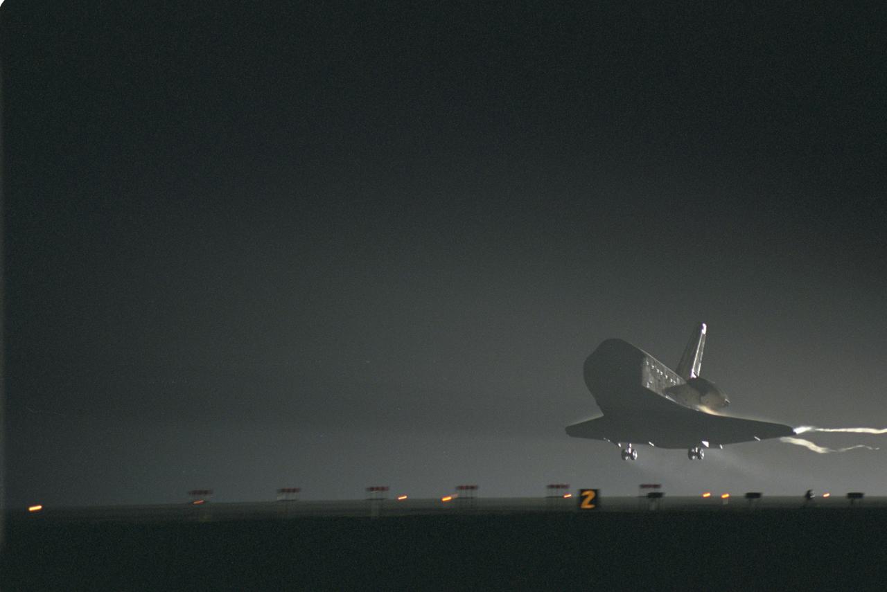 STS106-S-014 (20 September 2000) --- The Space Shuttle Atlantis nears its touchdown point on Runway 33 of the KSC Shuttle Landing Facility. Main gear touchdown was at 3:56:48 a.m. (EDT), September 20, 2000, landing on orbit 185 of the mission. Nose gear touchdown was at 3:56:57 a.m. EDT and wheel stop at 3:58:01 a.m. (EDT). Atlantis and crew traveled 4.9 million miles on the 11-day, 19-hour, 11-minute mission STS-106. During the mission to the International Space Station, the crew transferred nearly 5,000 pounds of equipment and supplies for use by the first resident crew expected to arrive in November. STS-106 was the 99th flight in the Shuttle program and the 22nd for Atlantis. STS-106 also marked the 15th nighttime landing in Shuttle history and the 23rd consecutive landing at KSC.