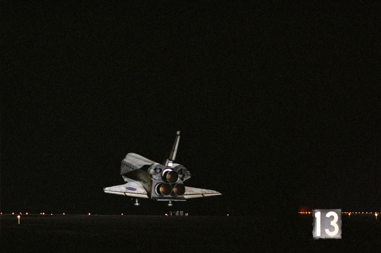 STS106-S-016 (20 September 2000) --- An aft view shows the Space Shuttle Atlantis nears its touchdown point on Runway 33 of the KSC Shuttle Landing Facility. Main gear touchdown was at 3:56:48 a.m. (EDT), September 20, 2000, landing on orbit 185 of the mission. Nose gear touchdown was at 3:56:57 a.m. EDT and wheel stop at 3:58:01 a.m. (EDT). Atlantis and crew traveled 4.9 million miles on the 11-day, 19-hour, 11-minute mission STS-106. During the mission to the International Space Station, the crew transferred nearly 5,000 pounds of equipment and supplies for use by the first resident crew expected to arrive in November. STS-106 was the 99th flight in the Shuttle program and the 22nd for Atlantis. STS-106 also marked the 15th nighttime landing in Shuttle history and the 23rd consecutive landing at KSC.
