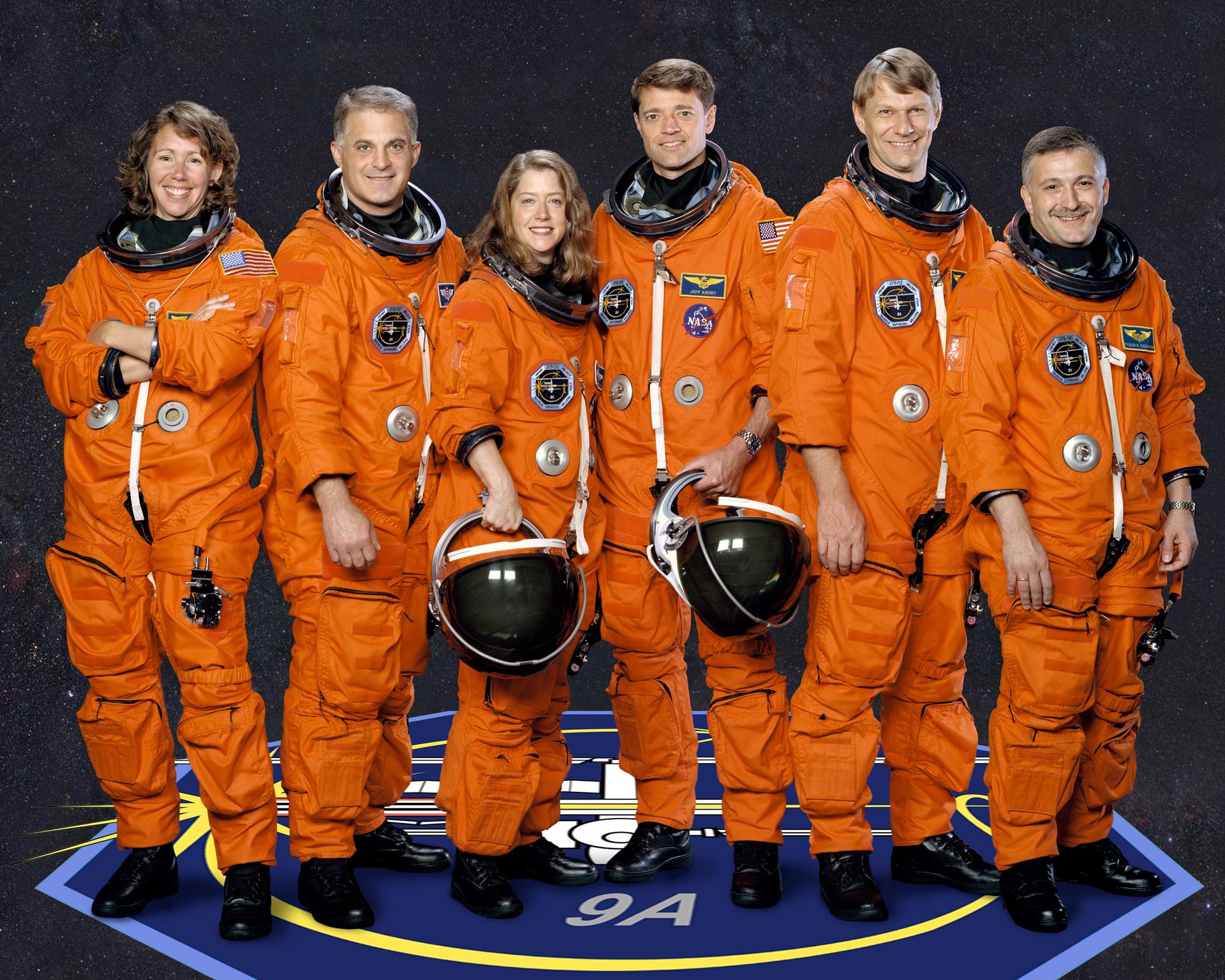 STS-112 crew portrait with crew in orange space suits standing