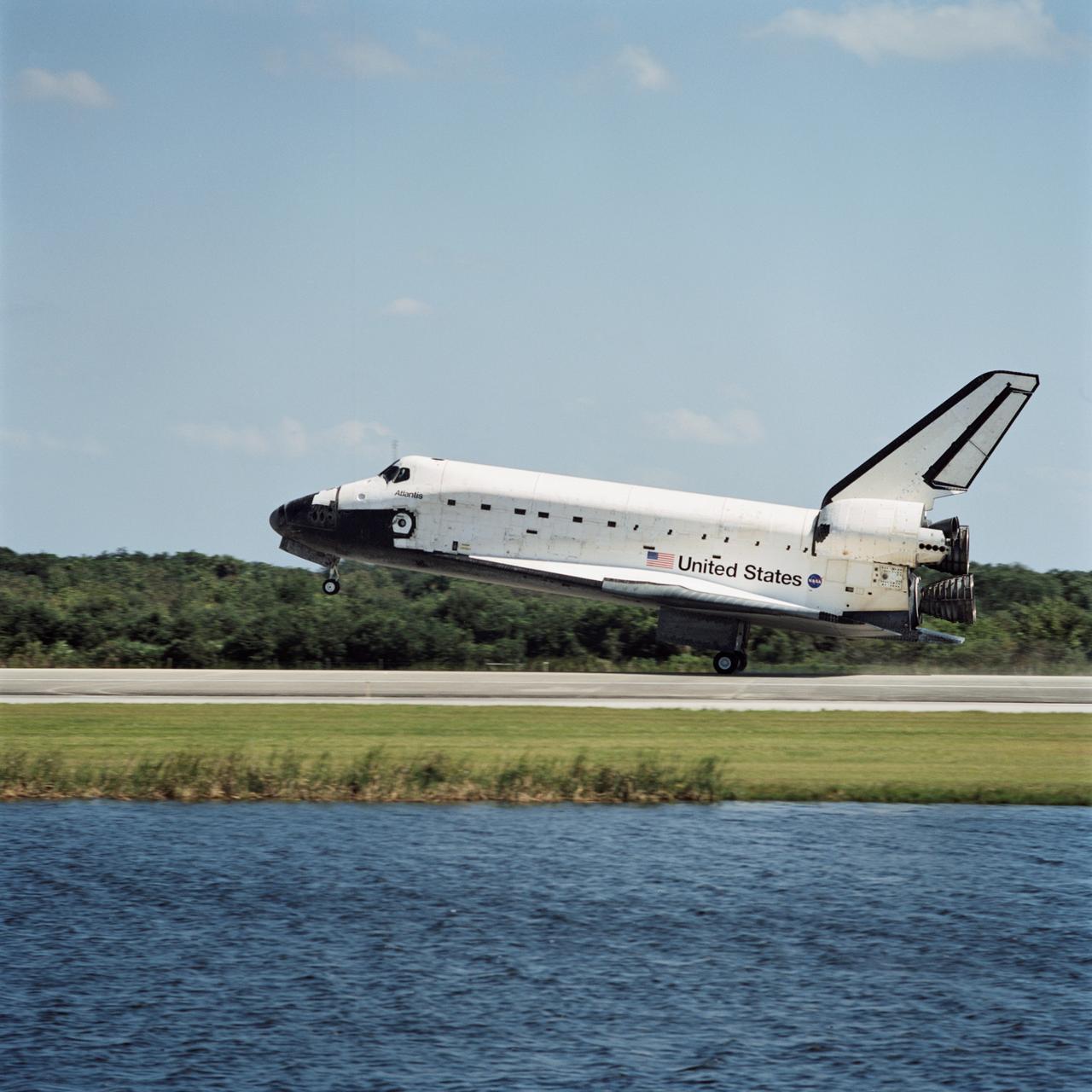 STS112-S-040 (18 October 2002) --- The main landing gear of the Space Shuttle Atlantis is just about to touch down at the Shuttle Landing Facility, completing the 4.5-million-mile journey to the International Space Station. Main gear touchdown occurred at 11:43:40 a.m. (EDT); nose gear touchdown at 11:43:48 a.m.; and wheel stop at 11:44:35 a.m. Mission elapsed time  was 10:19:58:44. Mission STS-112 expanded the size of the Station with the addition of the S1 truss segment. The returning crew of Atlantis are  Jeffrey S. Ashby,   commander;  Pamela A. Melroy, pilot;  and  David A. Wolf, Piers J. Sellers, Sandra H. Magnus and Rosaviakosmos' Fyodor N. Yurchikhin, all mission specialists. This landing is the 60th at KSC in the 21-year history of the Shuttle program.